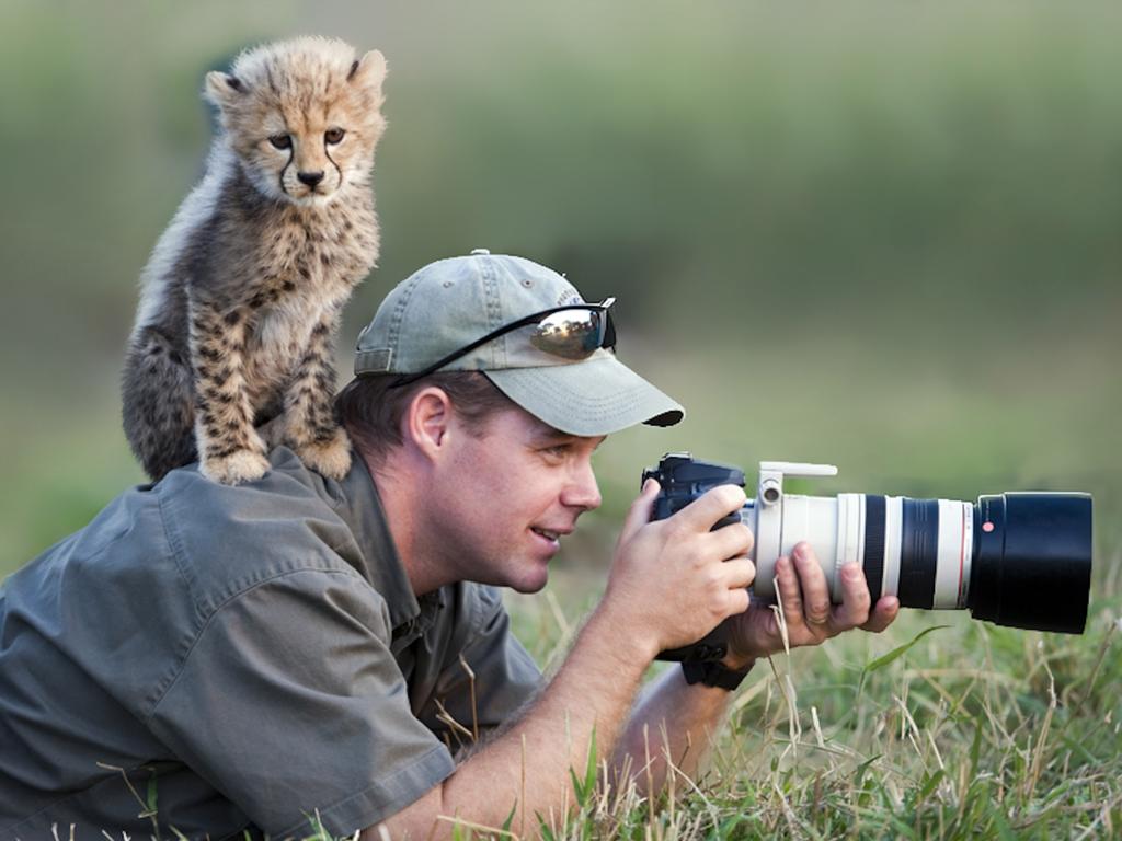 A human photographer waiting in a box